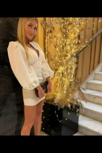 Classy blonde Edinburgh escort clutching her purse