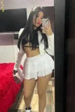 Young Birmingham escort in white taking a selfie