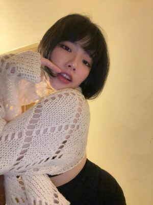 Busty Asian escort posing