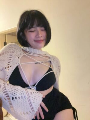 Busty Asian escort posing