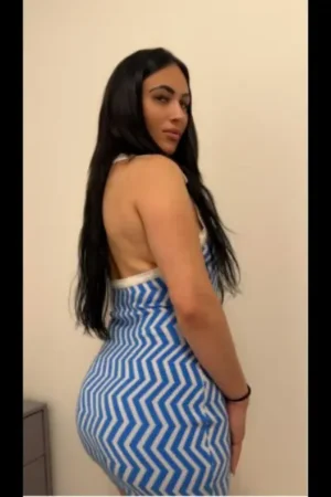 Brunette Birmingham escort in blue and white dress