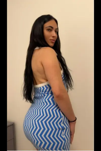 Brunette Birmingham escort in blue and white dress