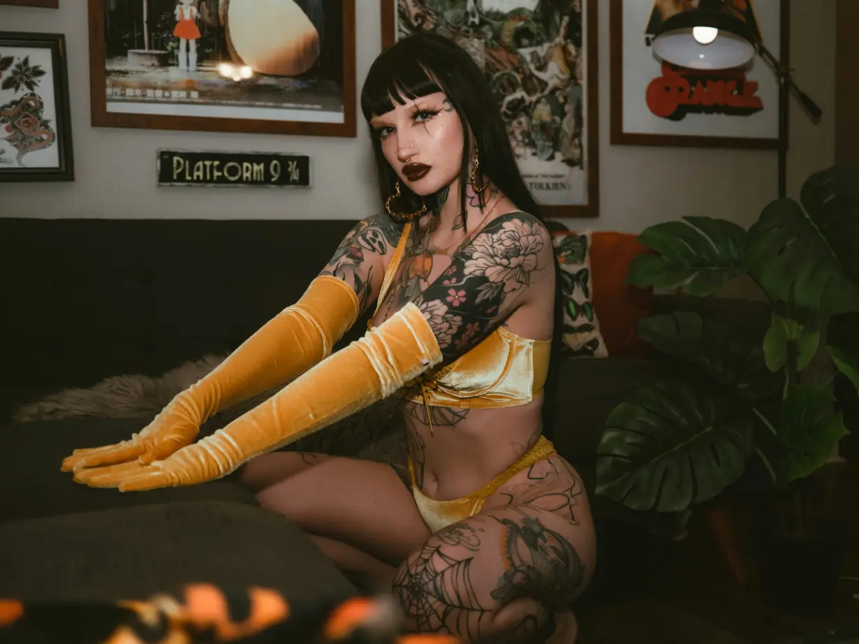 Tattooed Melrose escort in orange furry underwear