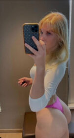 Blonde escort in pink panties taking a selfie