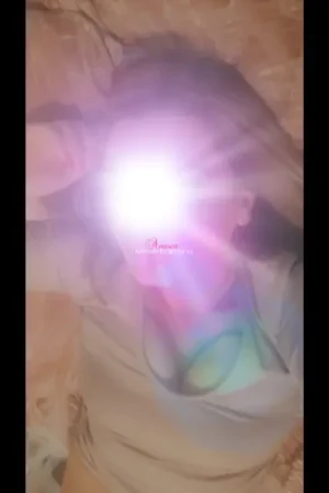 Mature Escort laid on her bed