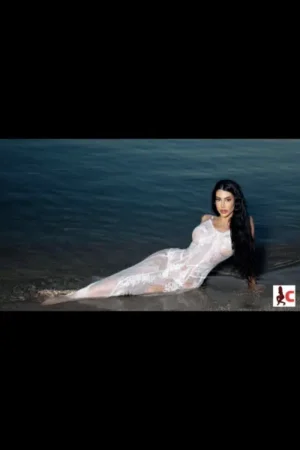 Hanna X in a white dress laid in the sea