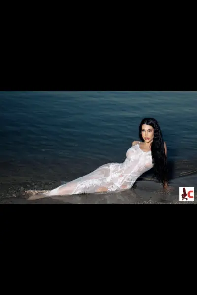 Hanna X in a white dress laid in the sea