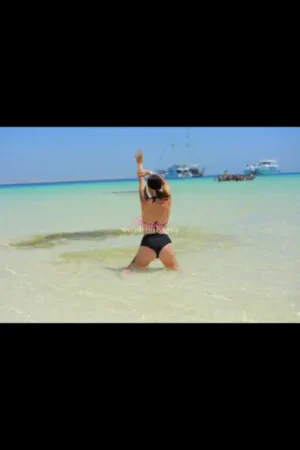 Tall brunette escort in the sea