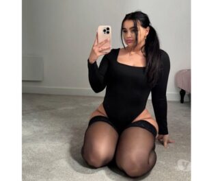 Spanish escort in a black corset and stockings