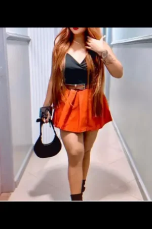 Ginger-haired Sheffield Escort in a orange skirt