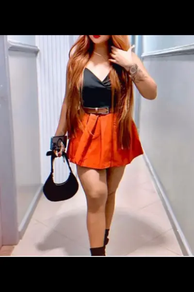 Ginger-haired Sheffield Escort in a orange skirt