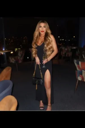 Blonde Birmingham escort clutching a black bag