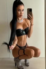 Petite Escort in black PVC lingerie