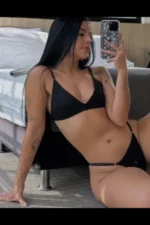 Tattooed Caribbean escort in black lingerie