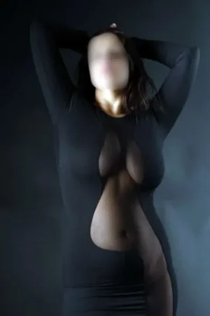 Busty Spanish Escort in a revealing black dress