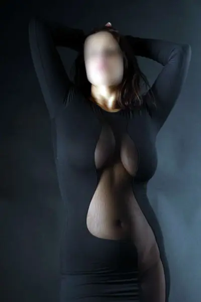 Busty Spanish Escort in a revealing black dress